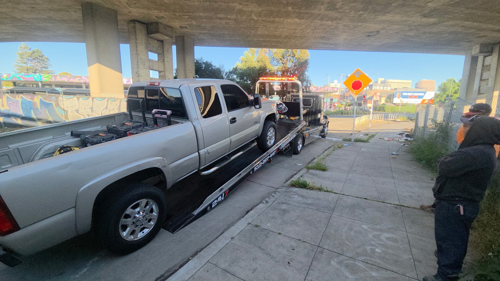 Chevy Silverado HD pickup loaded under freeway overpass